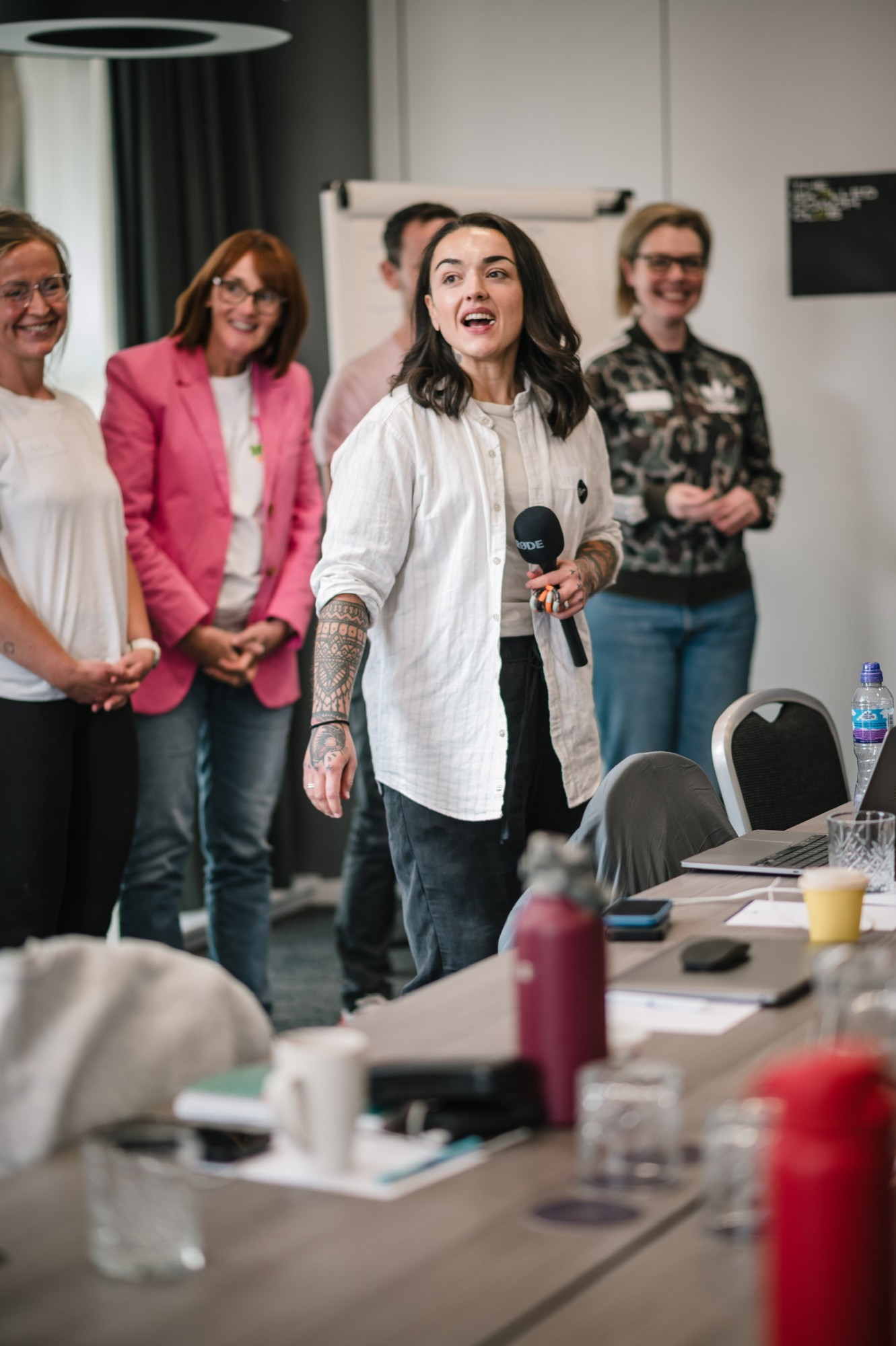 Alex Hindley leading a session, holding a microphone